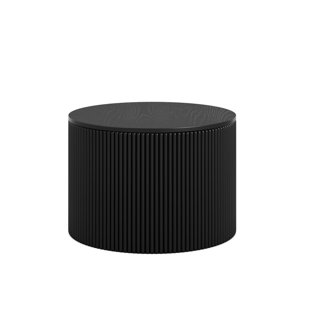 LPD Furniture Eden round black coffee table with textured top and ribbed base in a modern living room setting