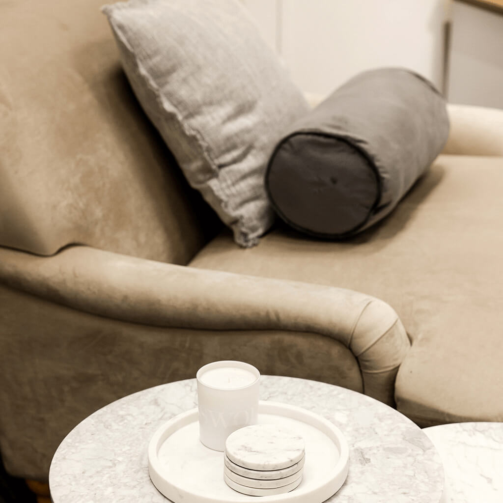 LPD Furniture Plumpton beige velvet armchair with wide cushioned seat in a modern living room setting