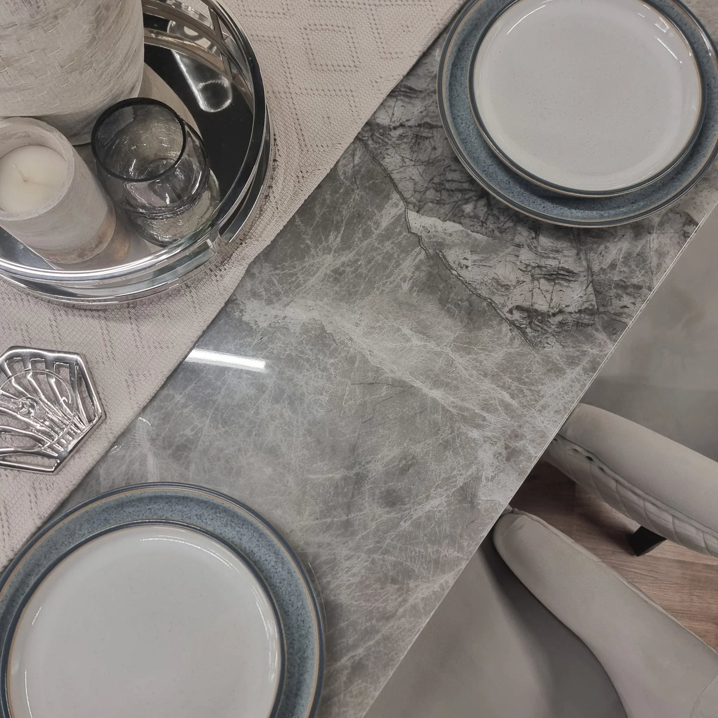 Furnish365 Roma marble dining table with hammered metal base in a contemporary dining room setting