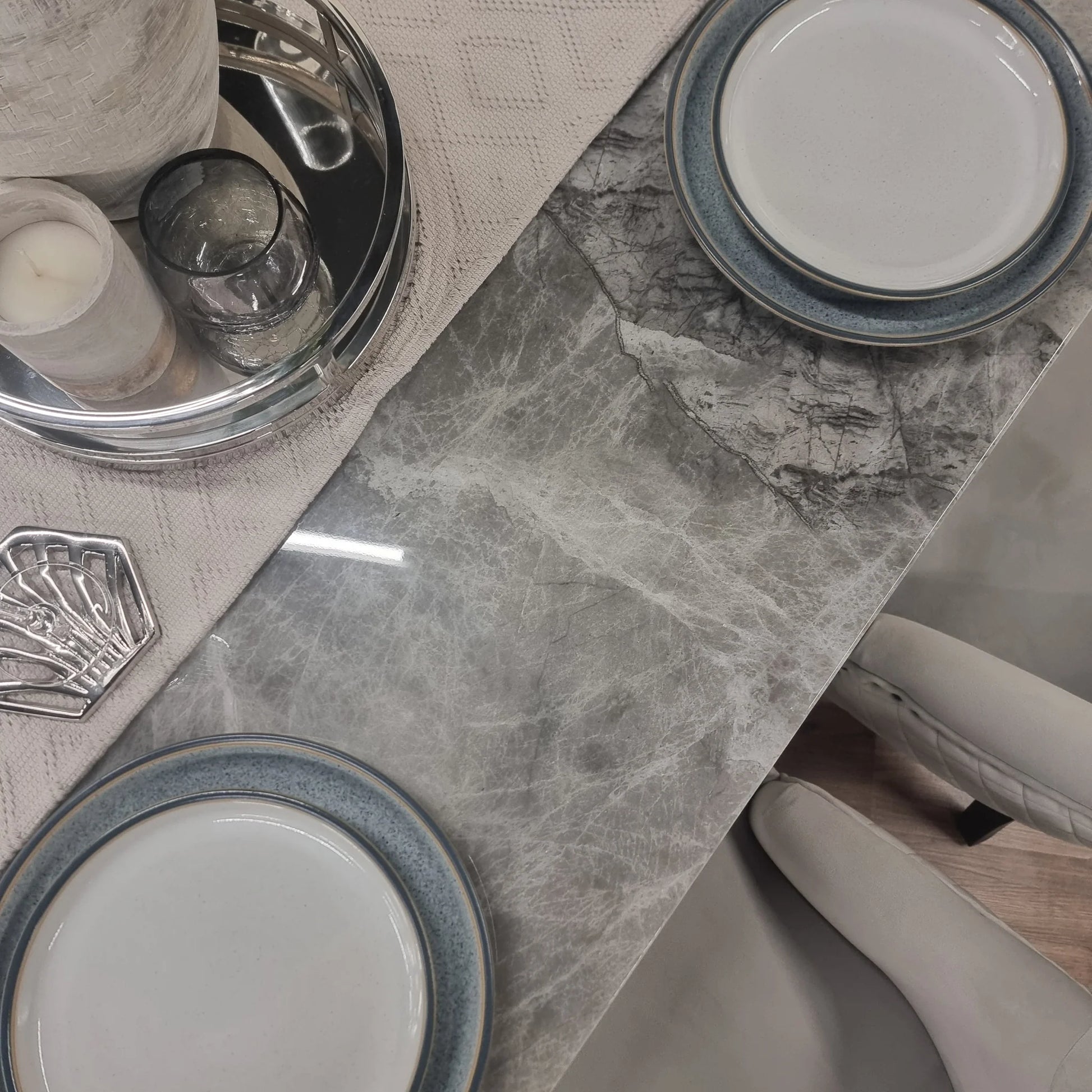 Furnish365 Roma marble dining table with hammered metal base in a contemporary dining room setting