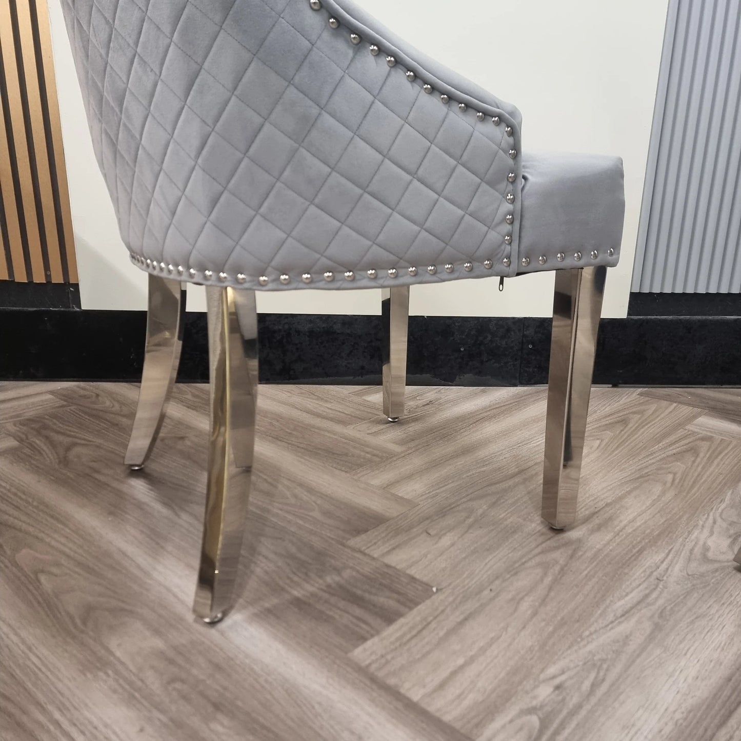 Furnish365 Bentley velvet dining chair with quilted back and chrome lion knocker in a modern dining setting
