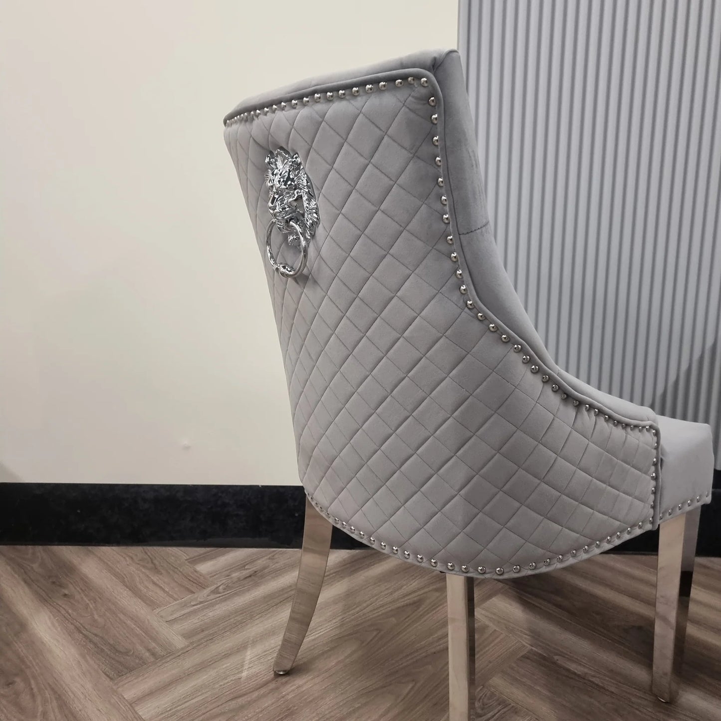 Furnish365 Bentley velvet dining chair with quilted back and chrome lion knocker in a modern dining setting