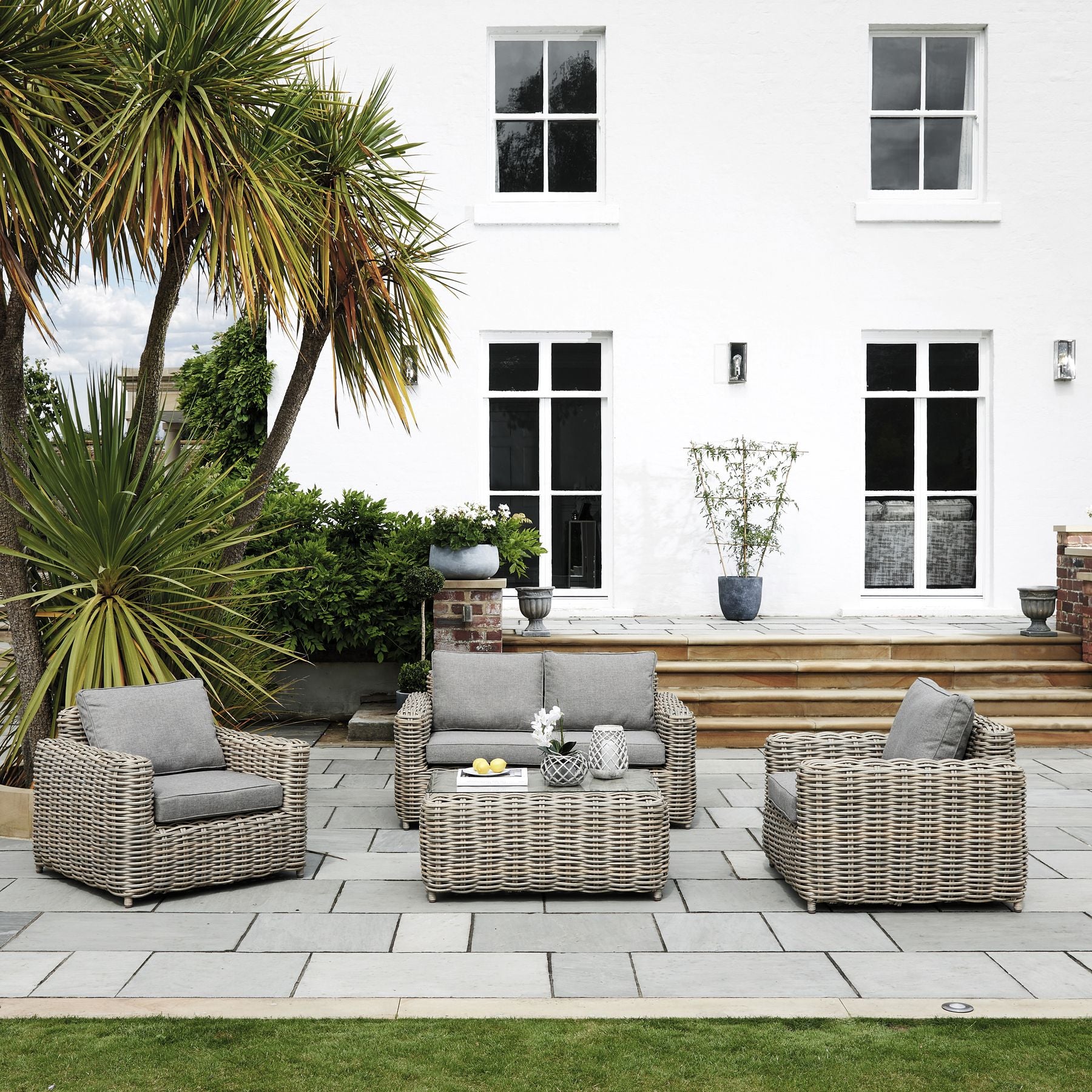 Hill Interiors Amalfi Collection outdoor four seater beige set in a modern garden setting