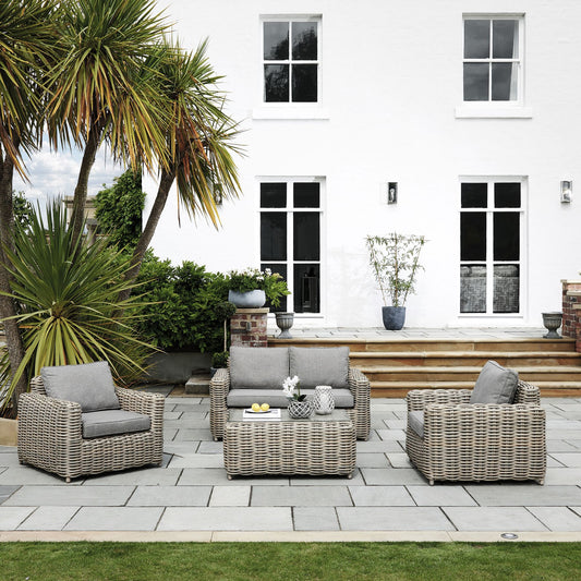 Hill Interiors Amalfi Collection outdoor four seater beige set in a modern garden setting
