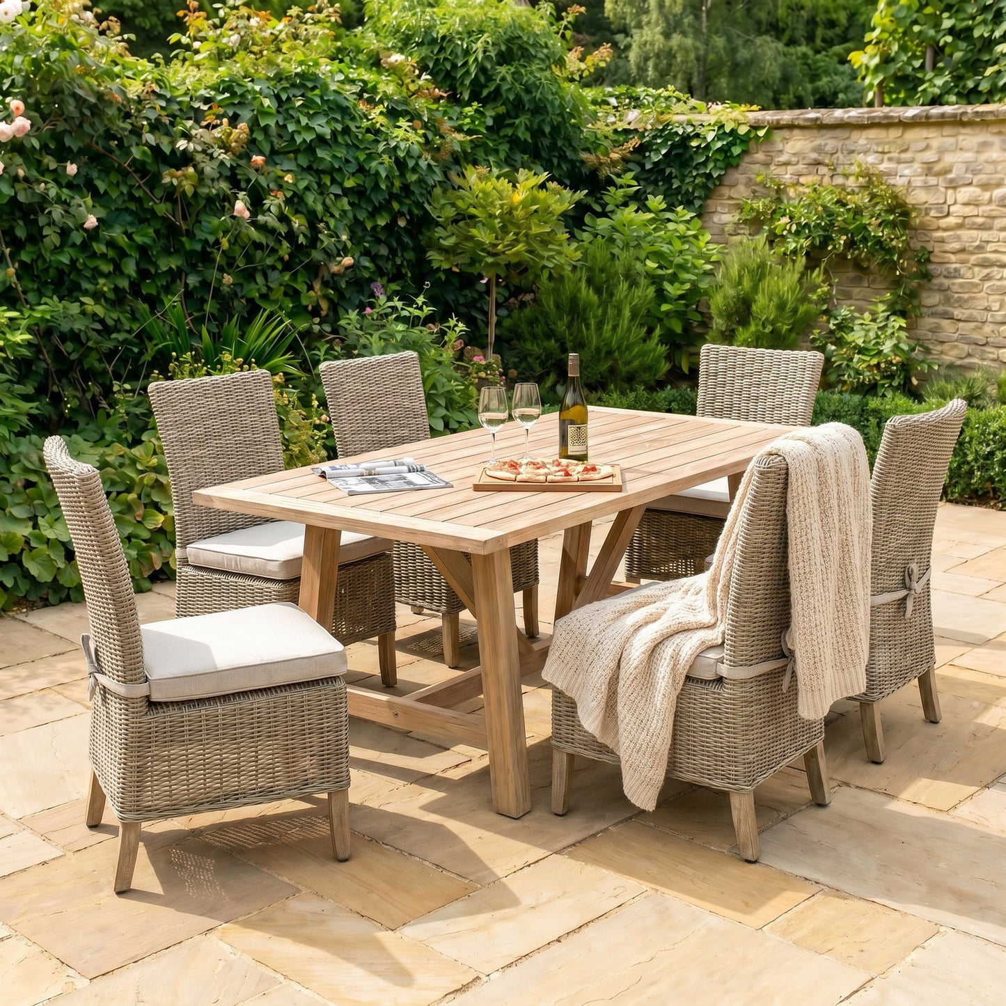 Hill Interiors Capri Collection beige outdoor dining chair in a modern garden setting