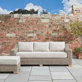 Side view of Hill Interiors Capri outdoor three seater sofa showing the beige fabric and metal frame
