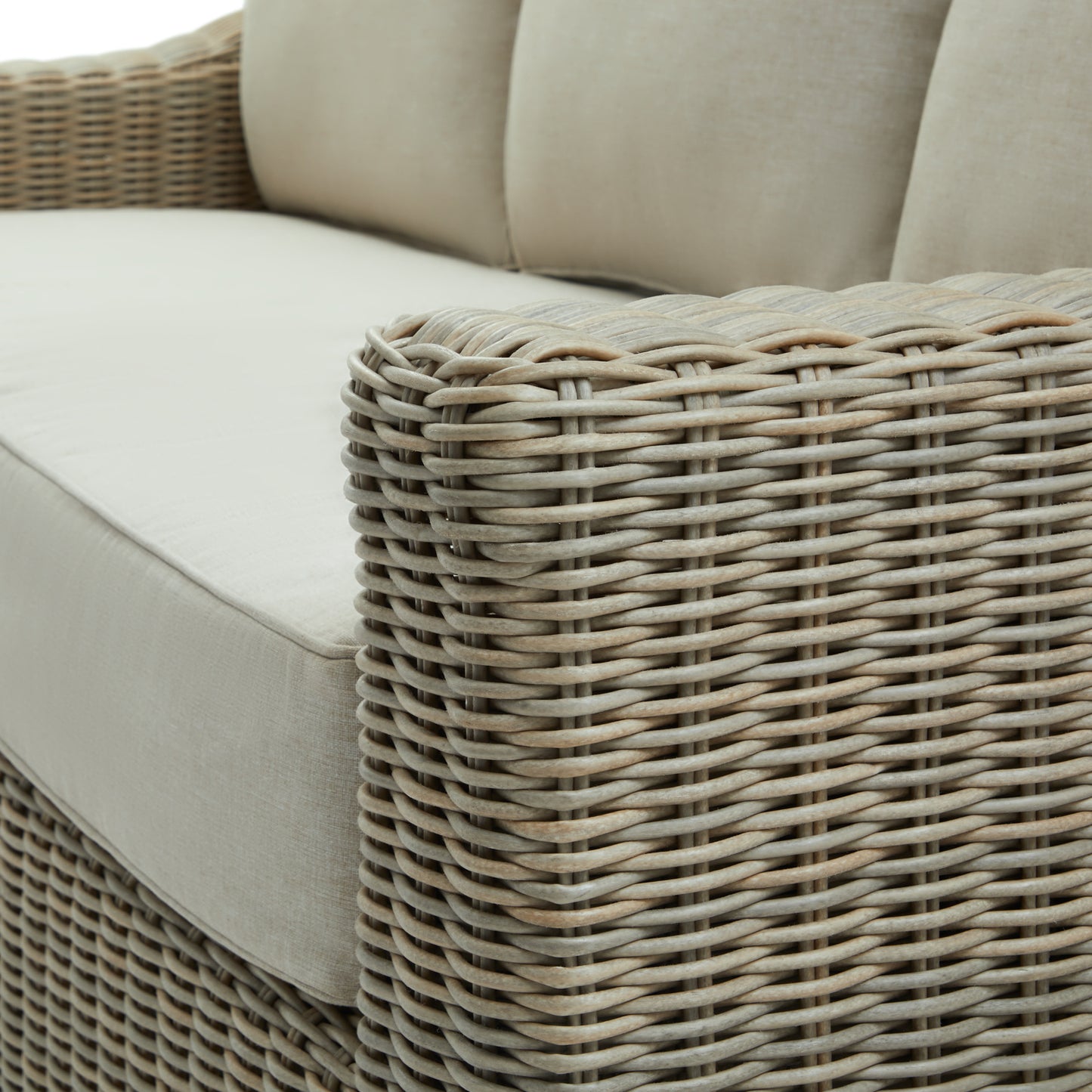Hill Interiors Capri beige outdoor sofa in a contemporary patio with natural lighting