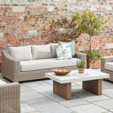 Hill Interiors Capri Collection beige outdoor three seater sofa in a modern garden setting
