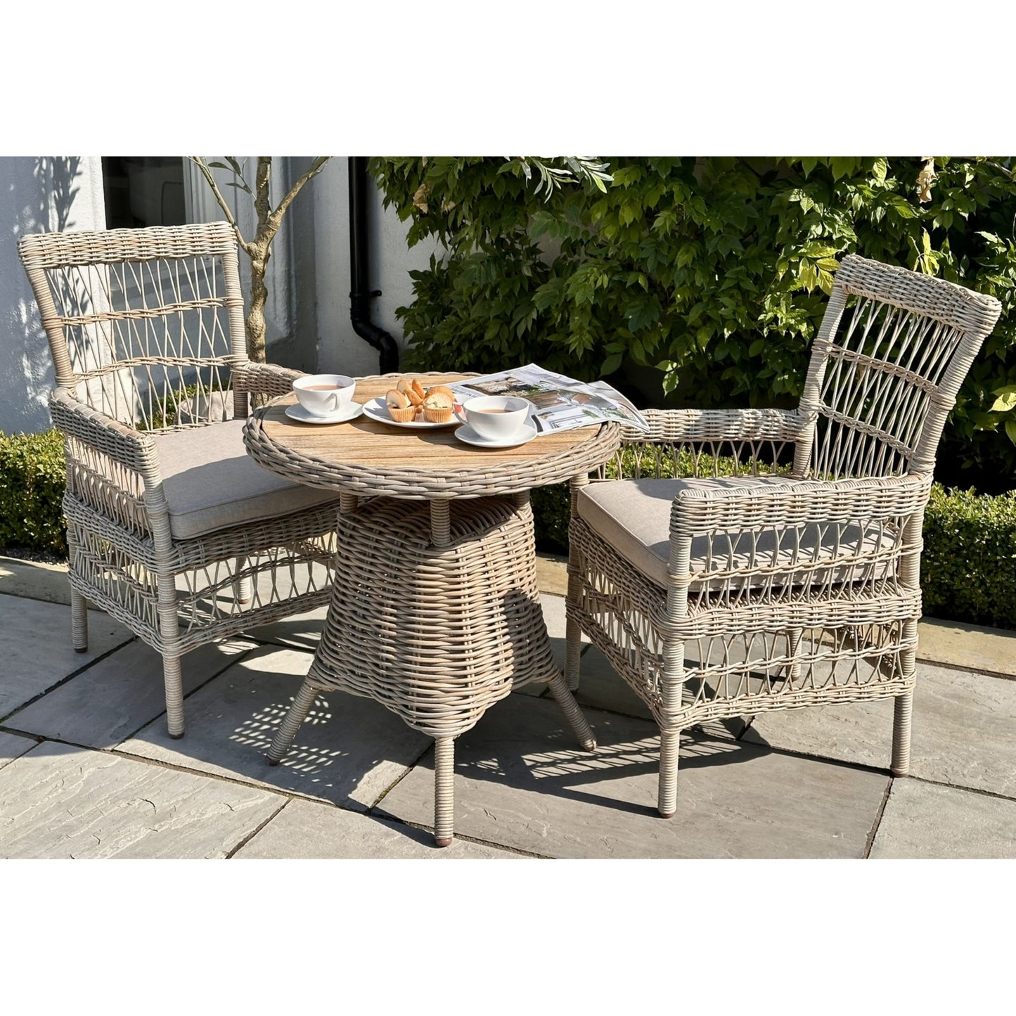 Hill Interiors Provence beige outdoor dining chair in a contemporary patio dining setting