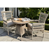 Hill Interiors Provence beige outdoor dining chair in a contemporary patio dining setting