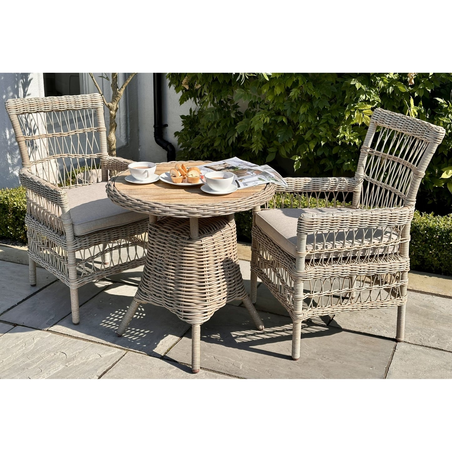 Side view of Hill Interiors Amalfi outdoor bistro table showing the wood top and metal frame