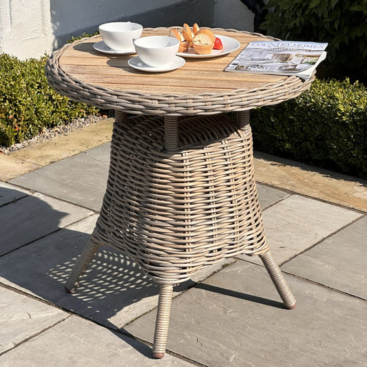 Hill Interiors Amalfi Collection outdoor bistro table with wood top and metal frame in a modern garden setting