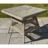 Hill Interiors Provence Collection outdoor 4 seater dining set with beige chairs and glass table in a modern garden setting