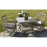 Hill Interiors Provence Collection outdoor 4 seater dining set with beige chairs and glass table in a modern garden setting