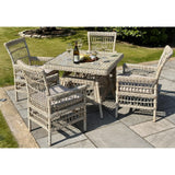Hill Interiors Provence Collection outdoor 4 seater dining set with beige chairs and glass table in a modern garden setting