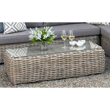 Hill Interiors Amalfi Collection beige outdoor large corner set with glass table in a modern garden setting