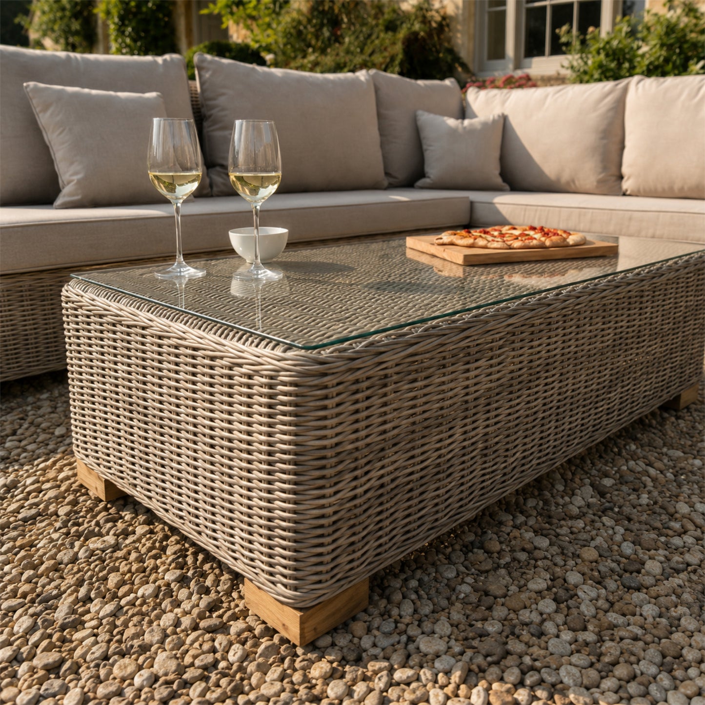 Hill Interiors Capri Collection beige outdoor large corner and coffee table set in a modern garden setting