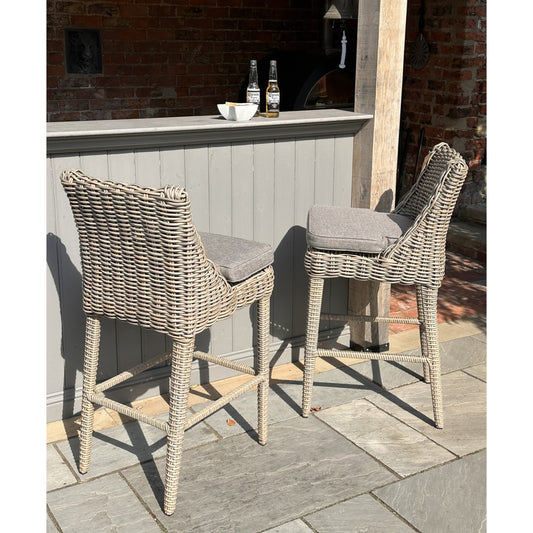 Hill Interiors Amalfi Collection beige outdoor bar stool in a modern garden bar setting
