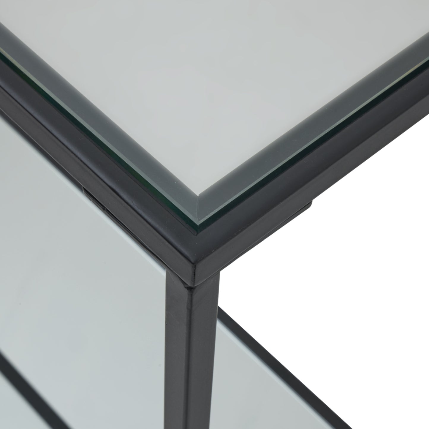 Close-up of Hill Interiors Lennox console table showcasing the mirrored glass and black metal finish