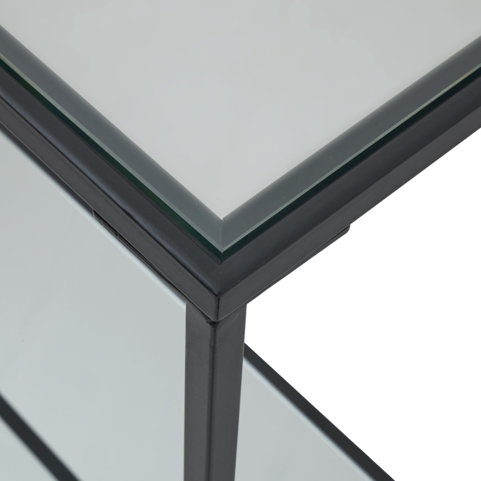 Close-up of Hill Interiors Lennox console table showcasing the mirrored glass and black metal finish