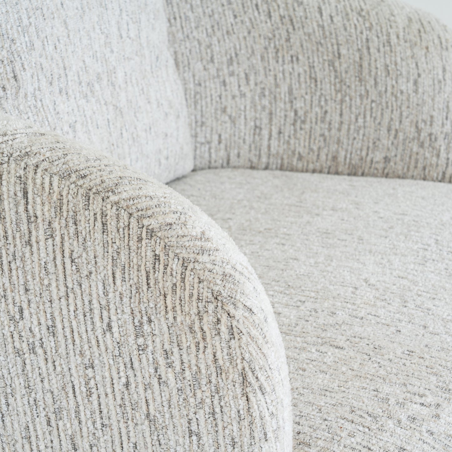 	Hill Interiors Sorelle swivel armchair from behind showing the contoured backrest and swivel mechanism