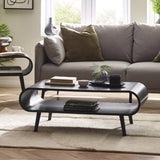	Apollo black ash coffee table with curved silhouette in a modern Scandinavian living room setting