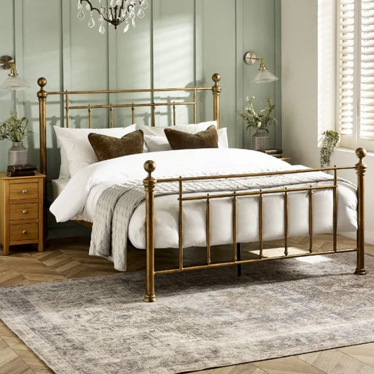 Aurelia brass effect metal bed in a modern bedroom setting