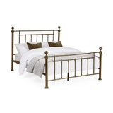 Aurelia brass effect metal bed in a modern bedroom setting
