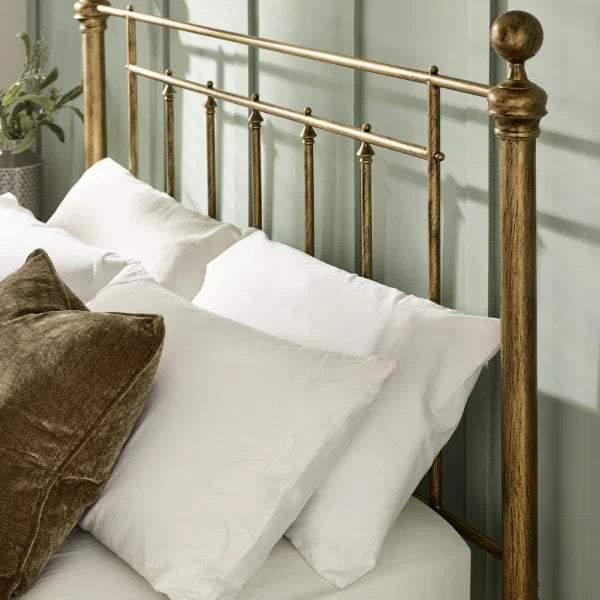 Aurelia brass effect metal bed in a modern bedroom setting