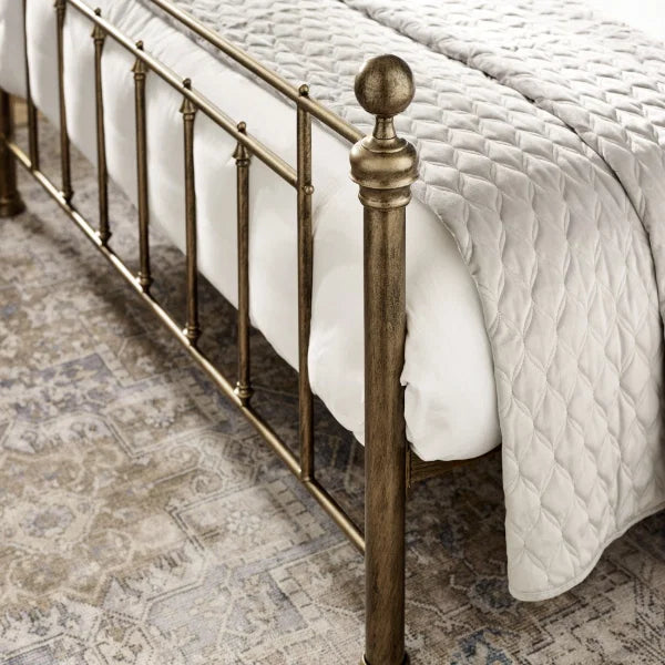 Aurelia brass effect metal bed in a modern bedroom setting