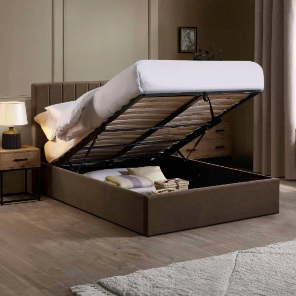 Aylen chocolate velvet ottoman storage bed with panelled headboard in a modern bedroom setting