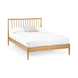 Belton natural oak spindle double bed with tapered legs in a modern bedroom setting