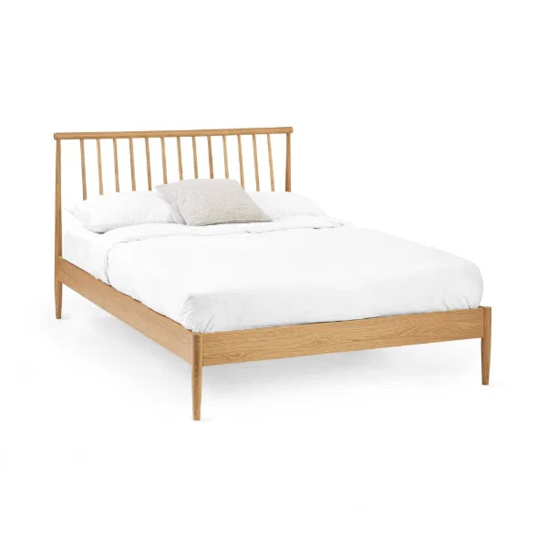 Belton natural oak spindle double bed with tapered legs in a modern bedroom setting