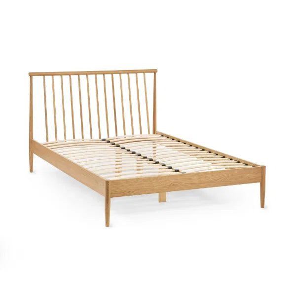 Belton natural oak spindle double bed with tapered legs in a modern bedroom setting