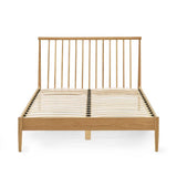 Belton natural oak spindle double bed with tapered legs in a modern bedroom setting