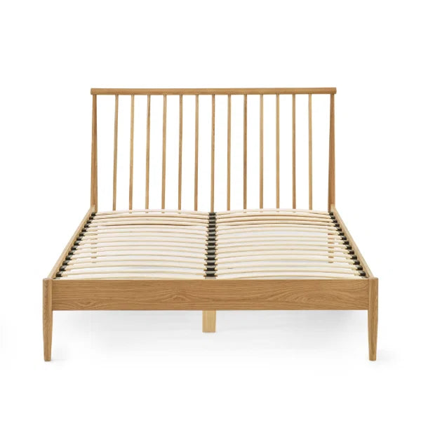 Belton natural oak spindle double bed with tapered legs in a modern bedroom setting
