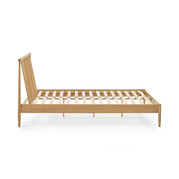 Belton natural oak spindle double bed with tapered legs in a modern bedroom setting