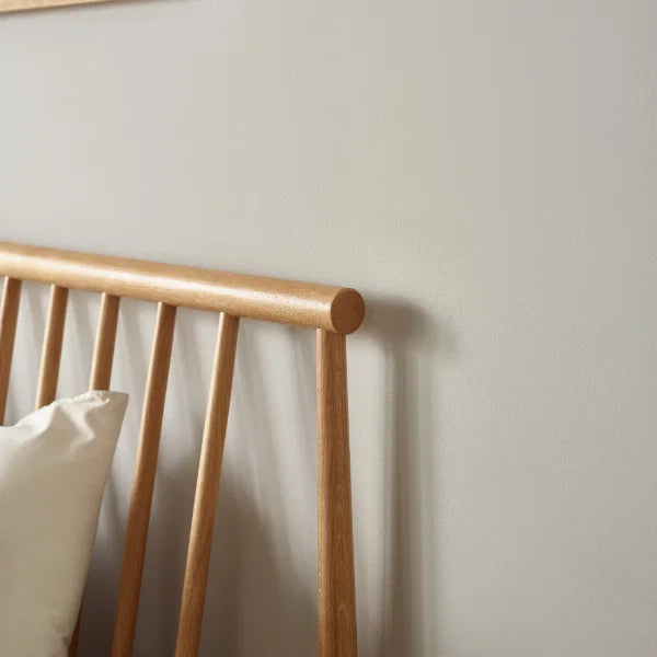 Belton natural oak spindle double bed with tapered legs in a modern bedroom setting