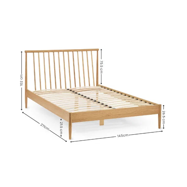 Belton natural oak spindle double bed with tapered legs in a modern bedroom setting