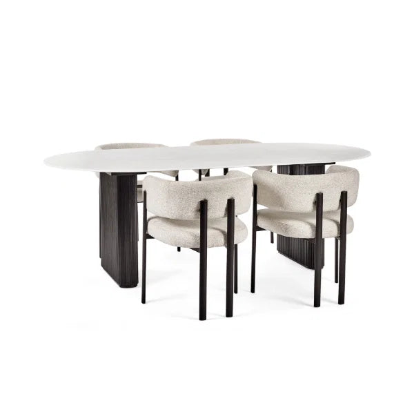 Bolivia oval marble-effect dining table with white glass top and fluted black pedestal legs in a modern dining room setting
