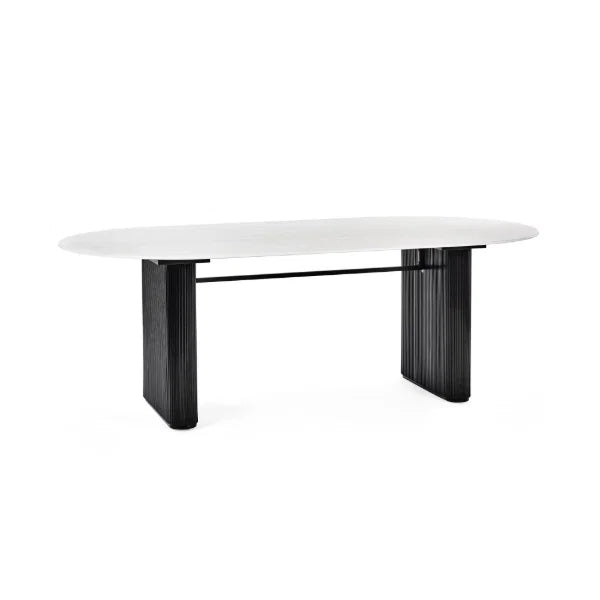 Bolivia oval marble-effect dining table with white glass top and fluted black pedestal legs in a modern dining room setting