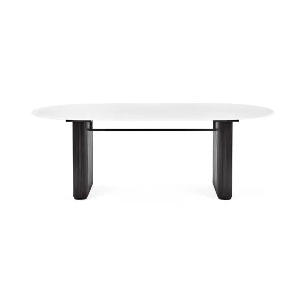 Bolivia oval marble-effect dining table with white glass top and fluted black pedestal legs in a modern dining room setting