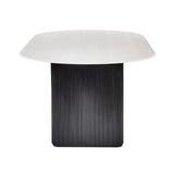 Bolivia oval marble-effect dining table with white glass top and fluted black pedestal legs in a modern dining room setting