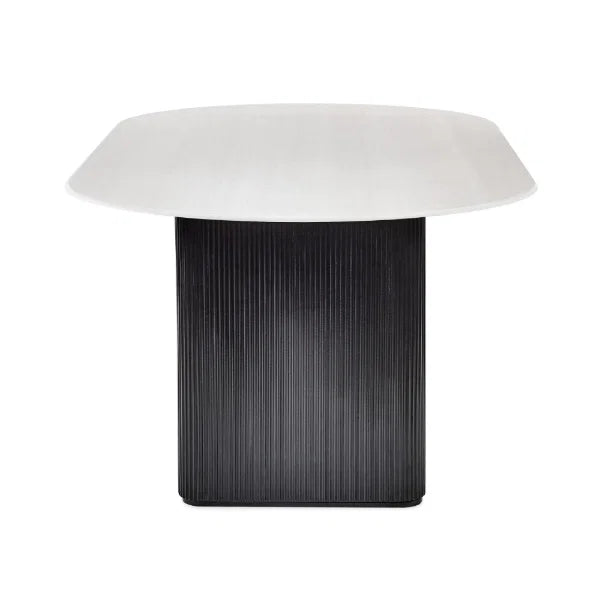 Bolivia oval marble-effect dining table with white glass top and fluted black pedestal legs in a modern dining room setting