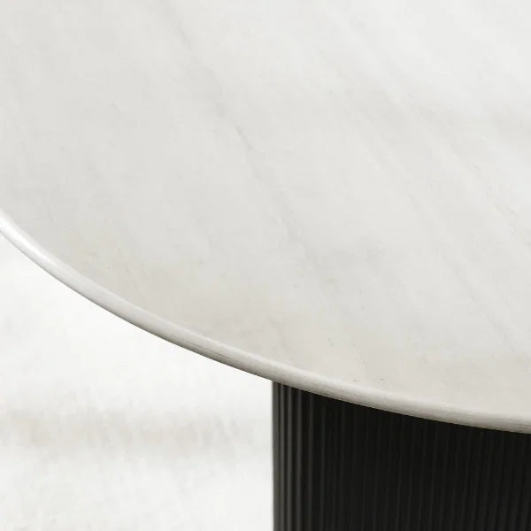 Bolivia oval marble-effect dining table with white glass top and fluted black pedestal legs in a modern dining room setting