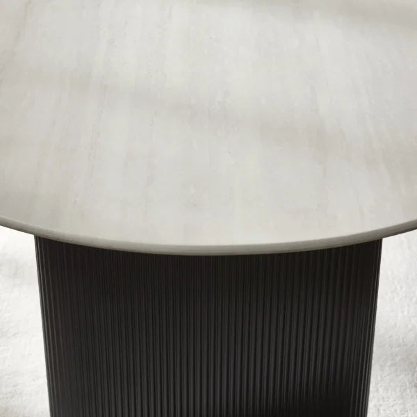 Bolivia oval marble-effect dining table with white glass top and fluted black pedestal legs in a modern dining room setting
