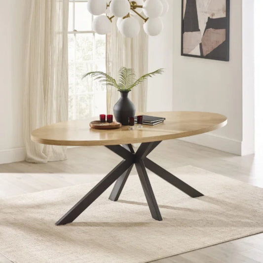 Bondi oval dining table with surfboard-shaped light oak top and black legs in a modern dining setting
