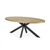 Bondi oval dining table with surfboard-shaped light oak top and black legs in a modern dining setting