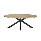Bondi oval dining table with surfboard-shaped light oak top and black legs in a modern dining setting