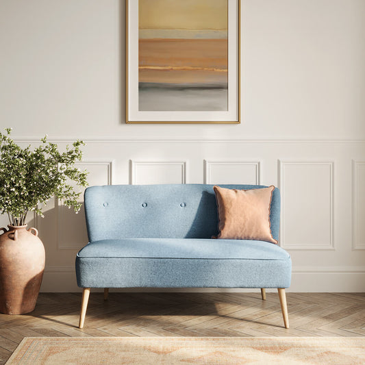 LPD Furniture Beau Cornflower Blue 2 seater sofa with tufted back and blonde wood legs in a modern living room setting